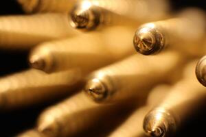 Golden Screws Background. Macro Closeup. Public Relation Promotional Concept. photo