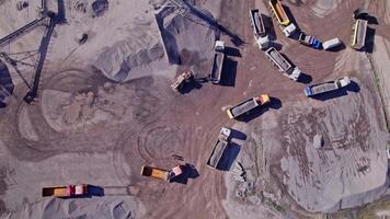 Excavator loading crushed stone into a dump truck in a crushed stone quarry video
