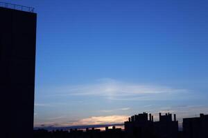 Urban Architecture Silhouette on Blue Night Sky Background photo