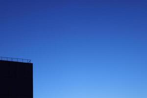Black House Silhouette Corner on Blue Night Sky Background photo