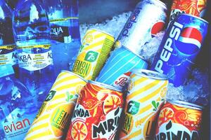 Fresh soda juice drinks in cans and bottles in ice. photo