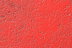Red painted asphalt texture. Colored road surface background. photo