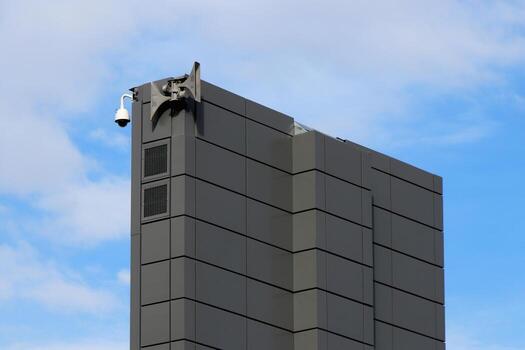 Gray lined construction with dynamics and camera on blue sky with clouds background. photo