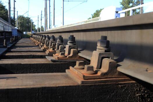 Bolts and lining the connection rails with tie leaving into the distance. photo