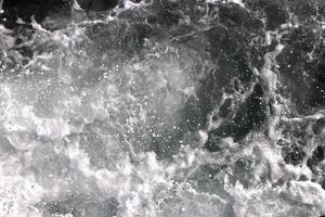 Sea wave foam texture. Marine aqua motion surface background. Outdoor water froth swirls backdrop. photo