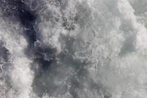 Marine aqua motion surface background. Sea wave foam texture. Outdoor water froth swirls backdrop. photo