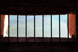 Ancient tower window with bars. Sea view. Bedesten Alanya fortress. Turkey. photo