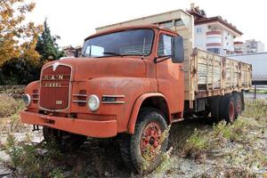 Weathered red retro rusty truck. Vintage aged vehicle. photo