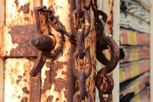 Metallic rusted items. Rust truck lock mechanism with latch and chain. photo