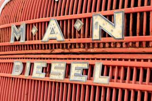 Weathered red retro rusty truck radiator panel with label Man diesel photo