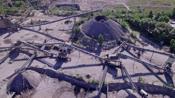 Excavator loading crushed stone into a dump truck in a crushed stone quarry video