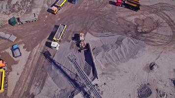 Excavator loading crushed stone into a dump truck in a crushed stone quarry video