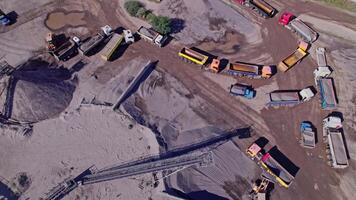 Excavator loading crushed stone into a dump truck in a crushed stone quarry video