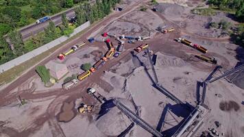 Excavator loading crushed stone into a dump truck in a crushed stone quarry video