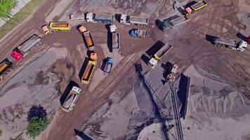 Excavator loading crushed stone into a dump truck in a crushed stone quarry video