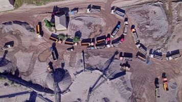 Excavator loading crushed stone into a dump truck in a crushed stone quarry video