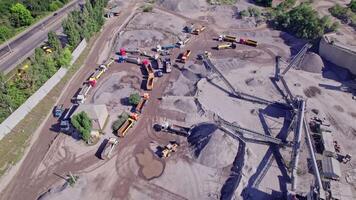 Excavator loading crushed stone into a dump truck in a crushed stone quarry video