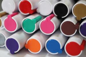 Colored market caps background. Pen markers multicolor caps macro closeup. Back to school composition. photo
