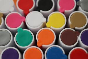 Back to school composition. Colored market caps background. Pen markers multicolor caps macro closeup. photo
