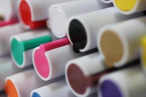 Back to school composition. Colored market caps background. Pen markers multicolor caps macro closeup. photo