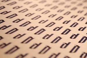 Lettering practice writing worksheet. Handwriting symbol filling pattern. Calligraphic letter D learning skills paper page. Calligraphy letters D background. photo