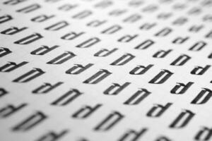 Handwriting black and white symbol filling pattern. Calligraphic letter D learning skills paper page. Calligraphy letters D background. Lettering practice writing worksheet. photo
