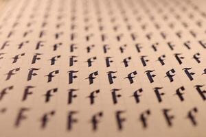 Calligraphic letter F learning skills paper page. Calligraphy letters F background. Lettering practice writing worksheet. Handwriting symbol filling pattern. photo