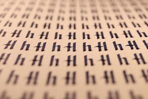 Calligraphic letter H learning skills paper page. Calligraphy letters H background. Lettering practice writing worksheet. Handwriting symbol filling pattern. photo