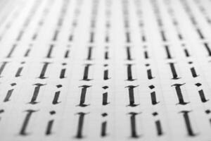 Handwriting black and white symbol filling pattern. Calligraphic letter I learning skills paper page. Calligraphy letters I background. Lettering practice writing worksheet. photo