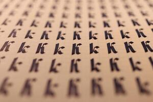 Handwriting symbol filling pattern. Calligraphic letter K learning skills paper page. Calligraphy letters k background. Lettering practice writing worksheet. photo