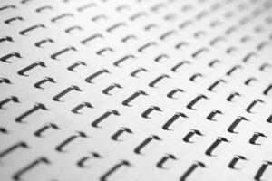 Handwriting black and white symbol filling pattern. Calligraphic letter C learning skills paper page. Calligraphy letters C background. Lettering practice writing worksheet. photo