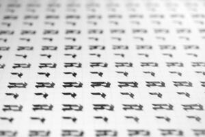 Calligraphy black and white letters R background. Lettering practice writing worksheet. Handwriting symbol filling pattern. Calligraphic letter r learning skills paper page. photo