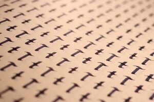 Lettering practice writing worksheet. Handwriting symbol filling pattern. Calligraphic letter T learning skills paper page. Calligraphy letters t background. photo
