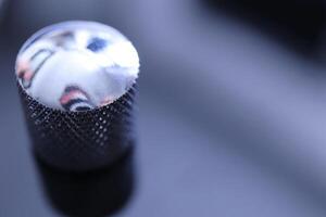 Metallic control knob macro closeup. Musician lifestyle instrument backdrop. Music instruments background. photo