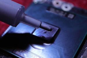 Applying thermal paste to the processor microchip. photo