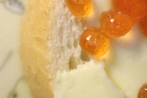 Red caviar on bread and butter. Macro closeup. photo