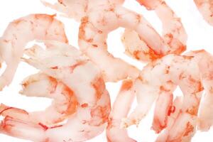 Isolated boiled peeled shrimps meat. Prawns seafood snack filling background. photo