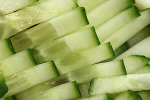 Sliced cucumber background. Diced salad ingredient texture. Fresh vitamin backdrop. photo