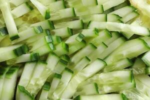 Diced salad ingredient texture. Fresh vitamin backdrop. Sliced cucumber background. photo