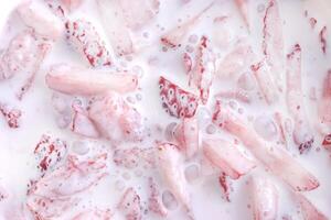 Cream in sliced strawberry filling background. Plum with red healthy tasty strawberry texture. Fresh vitamin berry backdrop. photo