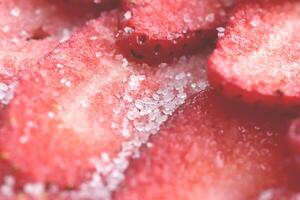 Sliced strawberry in sugar filling background. Red healthy tasty strawberry with sugar texture. Fresh vitamin berry backdrop. photo