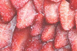 Red healthy tasty strawberry with sugar plum texture. Fresh vitamin berry backdrop. Sliced strawberry in sugar cream filling background. photo
