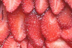 Red healthy tasty strawberry with sugar texture. Fresh vitamin berry backdrop. Sliced strawberry in sugar filling background. photo