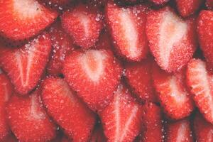 Fresh vitamin berry backdrop. Sliced strawberry in sugar filling background. Red healthy tasty strawberry with sugar texture. photo
