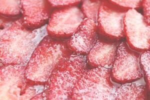 Fresh vitamin berry backdrop. Sliced strawberry in sugar cream filling background. Red healthy tasty strawberry with sugar plum texture. photo