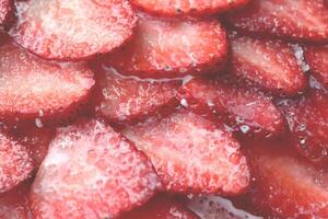 Red healthy tasty strawberry with sugar plum texture. Fresh vitamin berry backdrop. Sliced strawberry in sugar cream filling background. photo