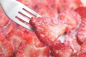 Fresh vitamin berry backdrop. Sliced strawberry in cream filling background. Red healthy tasty strawberry with plum texture. photo