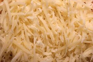 Grated cheese background. Parmesan filling texture. photo