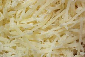Grated cheese background. Parmesan filling texture. photo