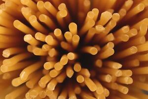 Macaroni backdrop. Pasta filling background. Spaghetti texture. photo